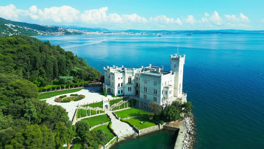 Perched on a rocky outcrop near Trieste, Castello di Miramare gazes over the deep-blue Adriatic, surrounded by manicured gardens and forested hills—a fairytale vision by the sea.