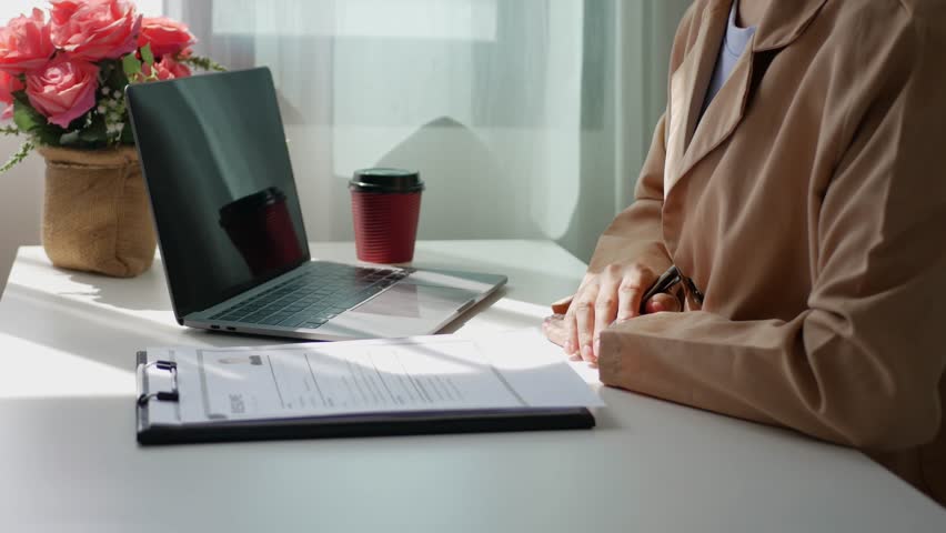Young businesswoman holds a resume and evaluates it. Views the personal history of job applicants. Recruitment concept.
