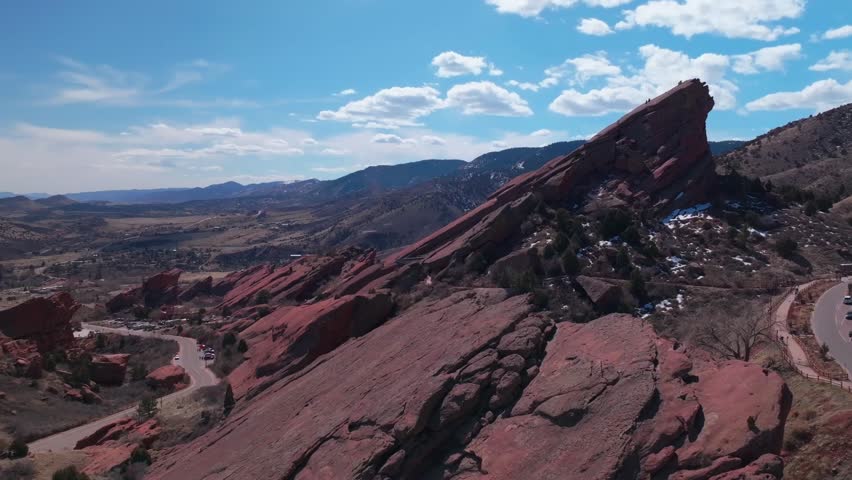 Red Rocks Park and Amphitheater Mount Morrison Colorado aerial drone mid winter windy roads walking trails Trading Post sunny blue sky clouds full parking lot cars stairs tourist area circle left