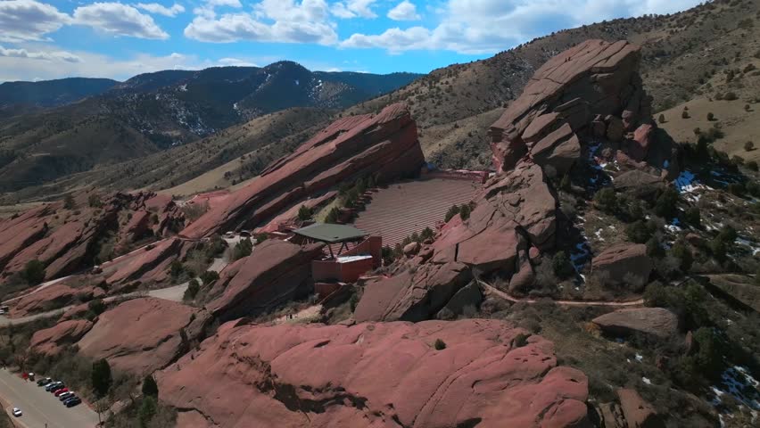 Red Rocks Park and Amphitheater Mount Morrison Colorado aerial drone mid winter windy roads walking trails Trading Post sunny blue sky clouds full parking lot cars stairs tourist area forward pan up