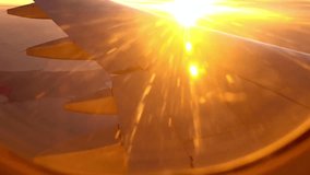 Airplane wing is silhouetted against the sun during a golden sunset - Powered by Shutterstock - Get 15% off with code: PIKWIZARD15