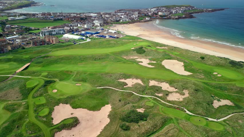 Wide 4K aerial video of Royal Portrush Golf Club and East Strand beach in Portrush, Northern Irelandin the UK. Filmed in 60 frames per second and with Rec709 color.