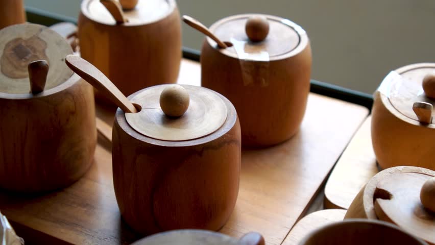 Wooden Containers with Lids and Spoons on Wooden Tray