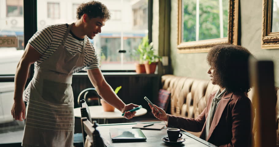 Cafe, waiter and payment service withPOS machine or phone for customer order, beverage or purchase. Woman, barista and man tap to pay with mobile smartphone for NFC, sale or checkout in coffee shop