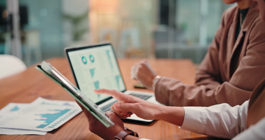 Tablet screen, hands and business people in meeting with graphs, investment or stock market. Laptop, team and women planning with chart for financial trading, scroll or performance analysis in office
