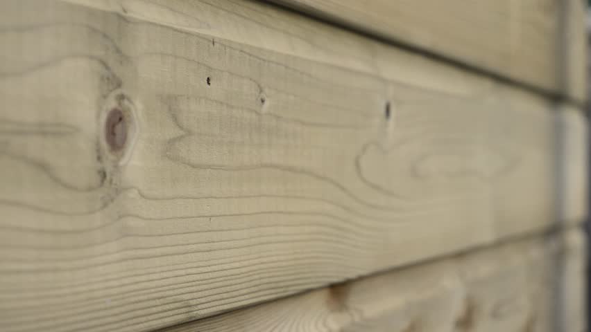 Carpenter's hands drive nails into wooden boards, close‑up DIY construction footage.