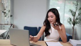 Office worker using smartphone voice notes app, recording audio message on mobile phone at workplace, sending voicemail, talking on speakerphone - Powered by Shutterstock - Get 15% off with code: PIKWIZARD15