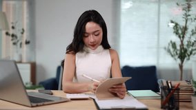 Professional businesswoman working remotely, analyzing data on digital tablet while taking detailed notes, demonstrating intense focus and concentration in modern home office setting - Powered by Shutterstock - Get 15% off with code: PIKWIZARD15