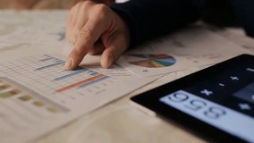 A businessman examines investment charts and financial data on a tablet, while analyzing graphs and using a calculator for precise calculations.
 - Powered by Shutterstock - Get 15% off with code: PIKWIZARD15