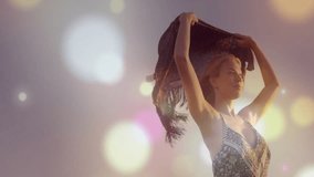 Low angle initiating pan revealing fashion model lifting shawl on beach catching light and bokeh. Bohemian, leisure, elegance, serenity, nature, outdoor, flowing - Powered by Shutterstock - Get 15% off with code: PIKWIZARD15