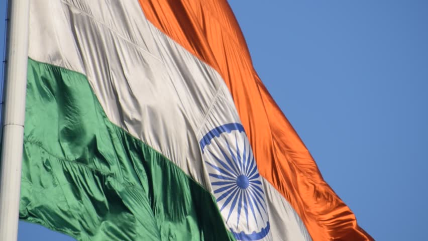 India flag flying high at Connaught Place with pride with plain white background, India flag fluttering, Indian Flag on Independence Day and Republic Day of India, tilt up shot, Har Ghar Tiranga