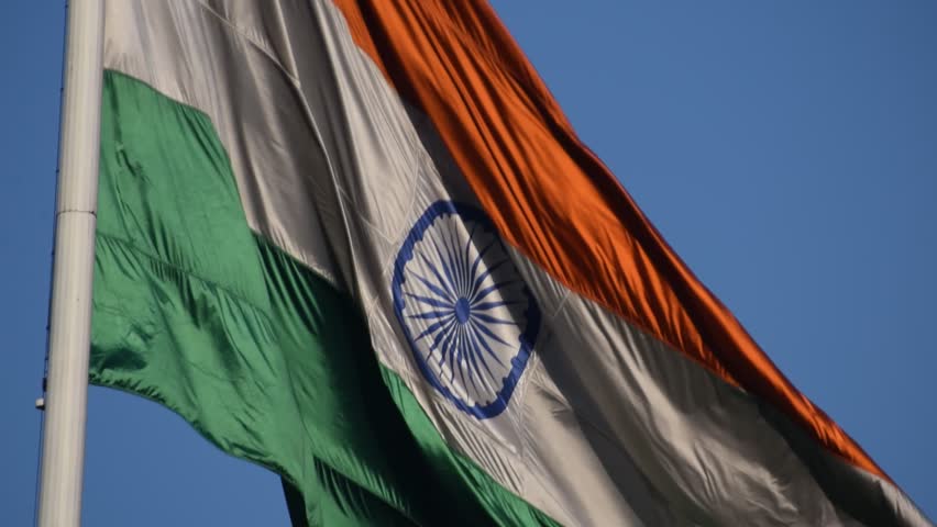India flag flying high at Connaught Place with pride with plain white background, India flag fluttering, Indian Flag on Independence Day and Republic Day of India, tilt up shot, Har Ghar Tiranga