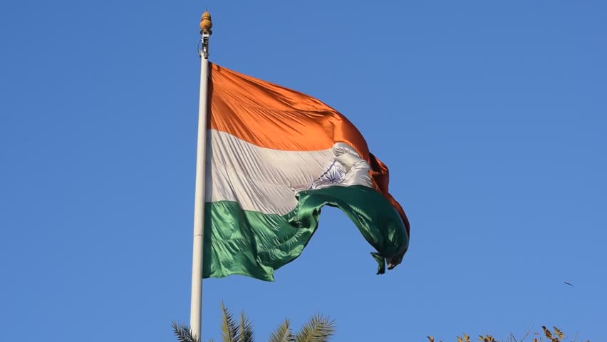 India flag flying high at Connaught Place with pride with plain white background, India flag fluttering, Indian Flag on Independence Day and Republic Day of India, tilt up shot, Har Ghar Tiranga