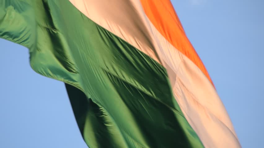 India flag flying high at Connaught Place with pride with plain white background, India flag fluttering, Indian Flag on Independence Day and Republic Day of India, tilt up shot, Har Ghar Tiranga