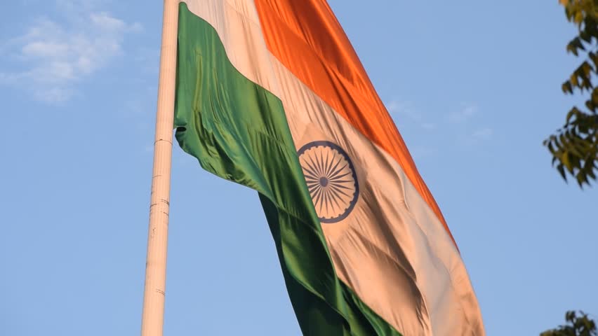 India flag flying high at Connaught Place with pride with plain white background, India flag fluttering, Indian Flag on Independence Day and Republic Day of India, tilt up shot, Har Ghar Tiranga