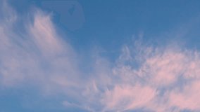 Beautiful Pure Blue Sunset Sky Light Feathery Pink Orange Clouds Slow Motion. Clear Blue Skyscraper with Cirrus Colorful Clouds Time Lapse, Heaven, Firmament, Atmosphere, Background 4K Relax Beauty - Powered by Shutterstock - Get 15% off with code: PIKWIZARD15