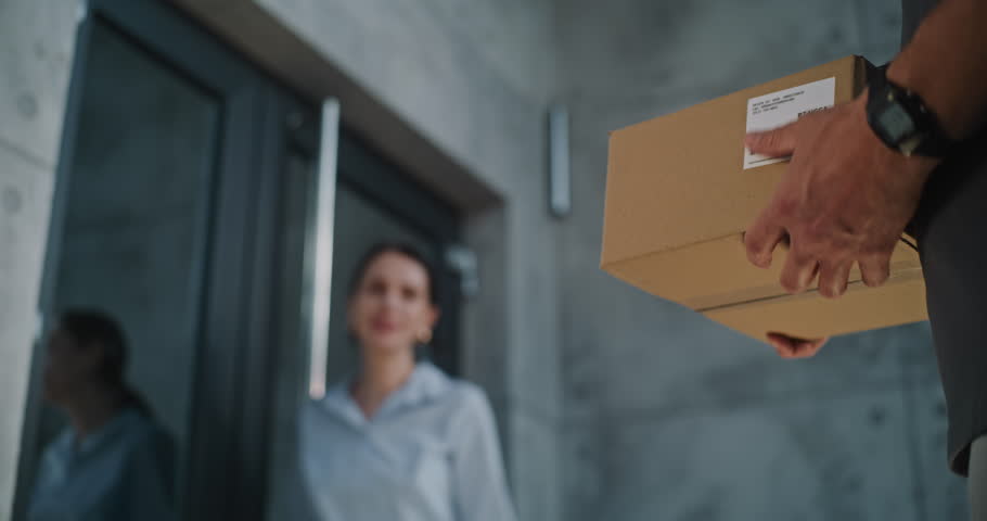 Close Up of Postman Delivering Parcel Box to Addressee in Modern Office, Getting Client's Signature on Digital Tablet. Businesswoman Taking Package with Online Shopping Order. Delivery, Postal Service