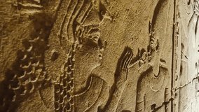 A detailed close-up of an ancient Egyptian bas-relief showing a pharaoh holding an ankh — the symbol of life — carved into weathered stone. - Powered by Shutterstock - Get 15% off with code: PIKWIZARD15