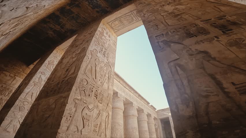 captivating view through a sunlit corridor of an ancient Egyptian temple, showcasing massive stone columns and walls intricately carved with hieroglyphics and pharaoh reliefs.