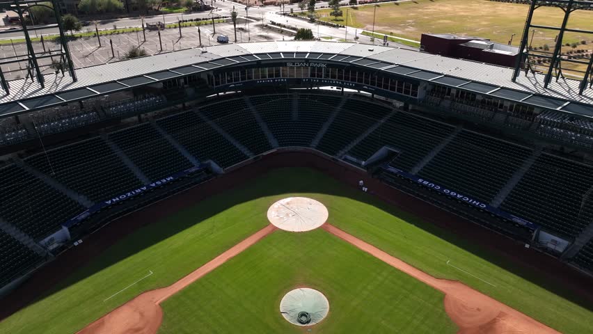 Aerial view of a baseball field, Sloan Park, showcasing vibrant green grass and clay contrasted against the stadium seating, Mesa, Arizona, United States.