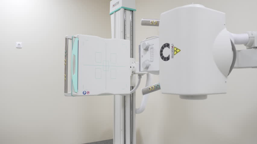 Newly installed x-ray machine rests in private clinic. Clean environment supports safe diagnostics. Light bounces off smooth white casing