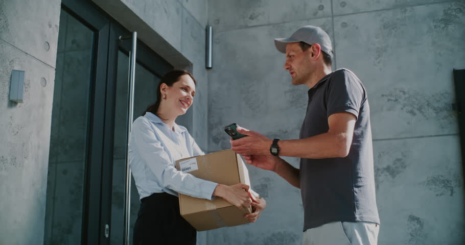 Postman Coming to Modern Office Building, Delivering Parcel Box for Recipient. Businesswoman Receiving Her Package with Online Shopping Order, Signing POD on Smartphone. Delivery or Postal Service.