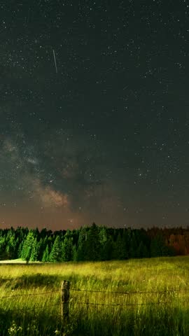 A breathtaking timelapse capturing the Milky Way filled with stars, while multiple satellites streak across the night sky, creating a dynamic and celestial scene