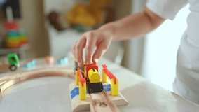 Close up kid hand playing with toy train. Wooden train set creates playful learning environment. Kid imagines new adventures while playing with train. Fun childhood memories, kid creative playtime. - Powered by Shutterstock - Get 15% off with code: PIKWIZARD15