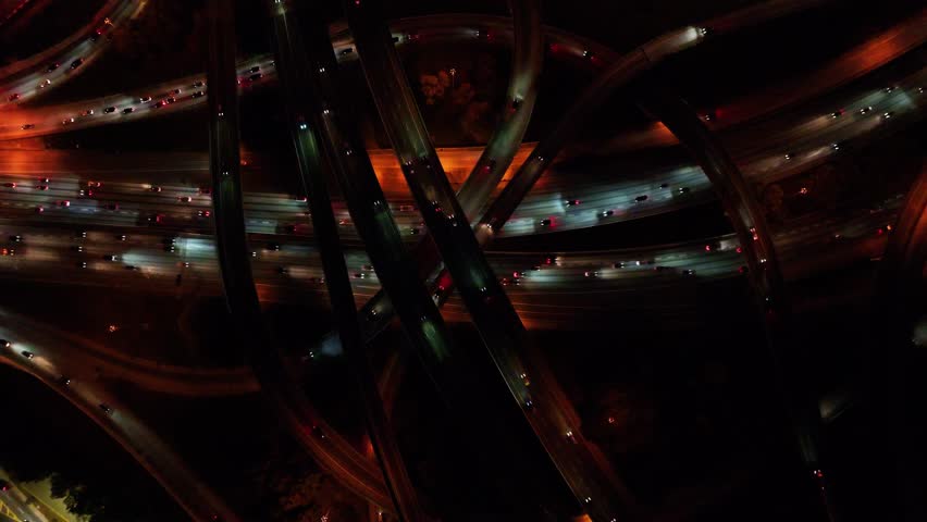 Aerial View of a complex network of illuminated roads at night. The roads are illuminated by street lights and vehicle headlights and taillights, Atlanta, Georgia, Country.
