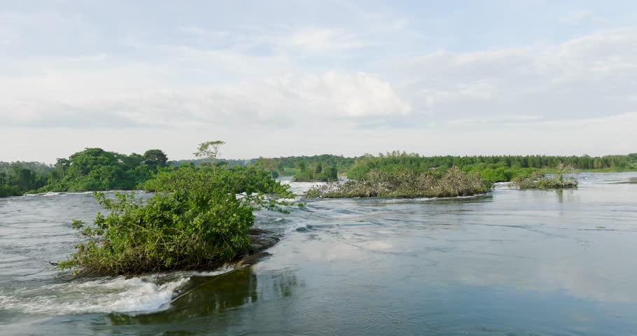 Aerial view of the river flowing around vibrant green vegetation and small islands, a stunning display of nature