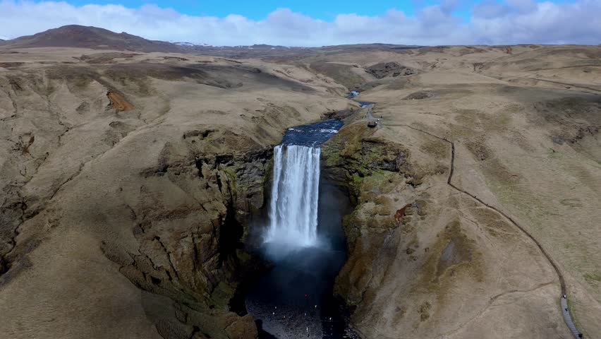 aerial view of skogafoss waterfall with rainbow travel tourist destination in Iceland drone wide angle