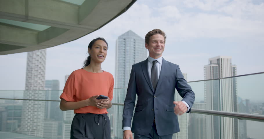 Business People Walking and Talking at Office Rooftop in City