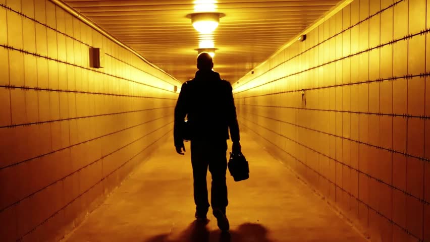 A man walks through a pedestrian crossing tunnel, a dark silhouette, looking for an exit. City communications of the big city of Saint Petersburg, Russia, July 5, 2024