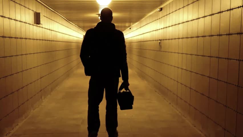 A man walks through a pedestrian crossing tunnel, a dark silhouette, looking for an exit. City communications of the big city of Saint Petersburg, Russia, July 5, 2024