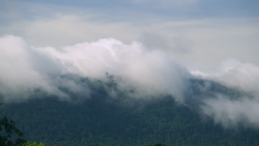 A large number of clouds are floating over the mountaintop in the rainy season morning.