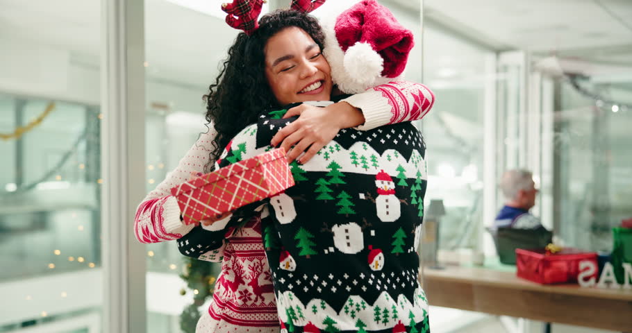 Christmas, office and business people hug with gift for festive surprise, celebration and giving present. Company, workers and happy woman and man with thank you for xmas holiday, tradition and event