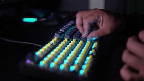 Close-up of hands installing keycaps on an RGB mechanical keyboard. Yellow switches and blue backlight create a modern tech aesthetic. Perfect for tech builds or gaming content. - Powered by Shutterstock - Get 15% off with code: PIKWIZARD15