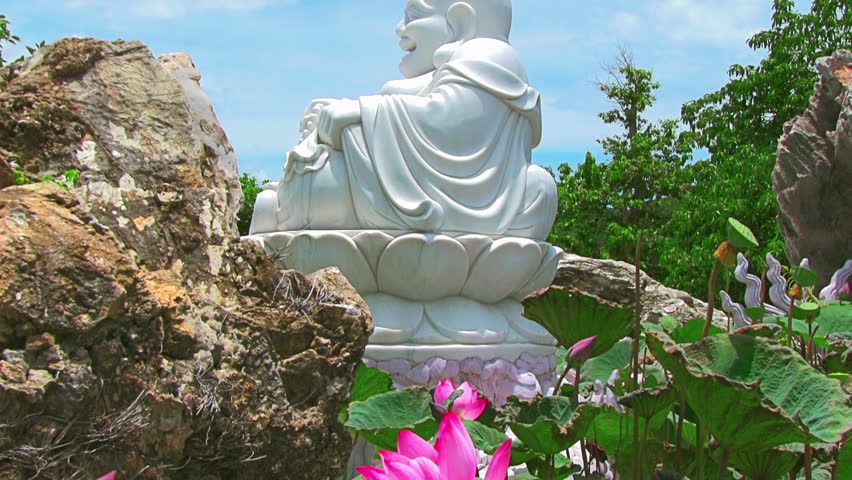 Buddha and lotus on blue sky background