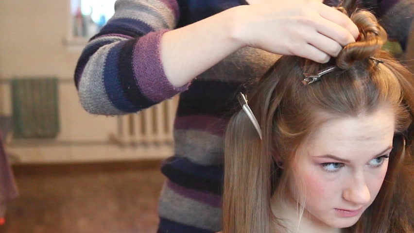 Beauty woman having her hairdo by stylist