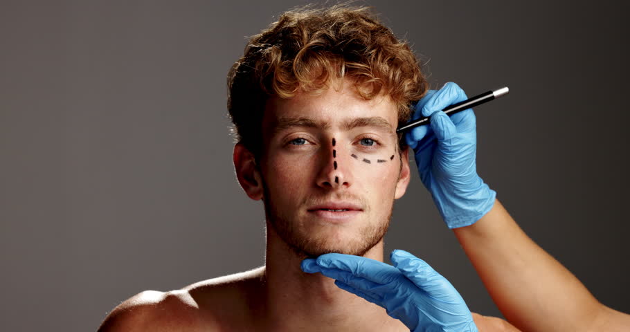 Man, face and pen for plastic surgery in studio with lines, aesthetic or transformation by background. Person, cosmetic surgeon and drawing on skin, portrait or hands with mockup space in Argentina