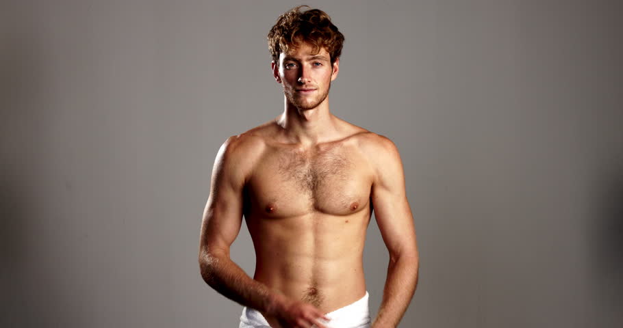 Studio, man and face with confidence for skincare, dermatology and happiness with body in towel. Mockup, male person and model in portrait for cosmetics, arms crossed and wellness in gray background