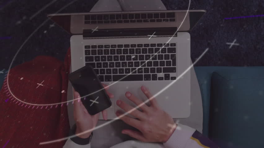 Man tapping smartphone initiating starfield overlay revealing rings typing on laptop for tech demo. Futuristic, digital, innovation, sleek, technology, creative, space-inspired
