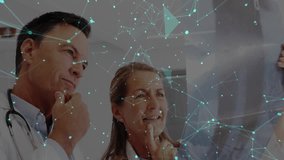 Senior doctor holding X-ray, activating network overlay, analyzing diagnosis while peer leaning in. Medical, collaboration, innovation, futuristic, healthcare, analysis, professionalism - Powered by Shutterstock - Get 15% off with code: PIKWIZARD15