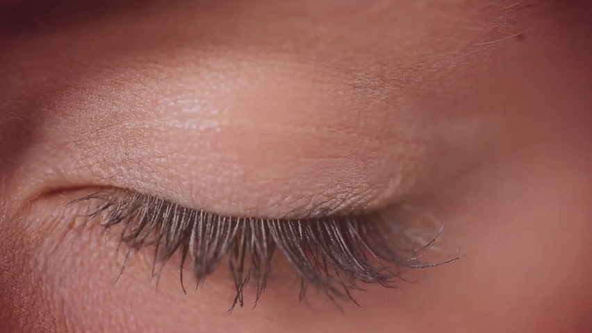 Closed eye opening revealing blue iris while holographic interface performing biometric scanning. Futuristic, technology, biometric, interface, cyber, data, analysis
