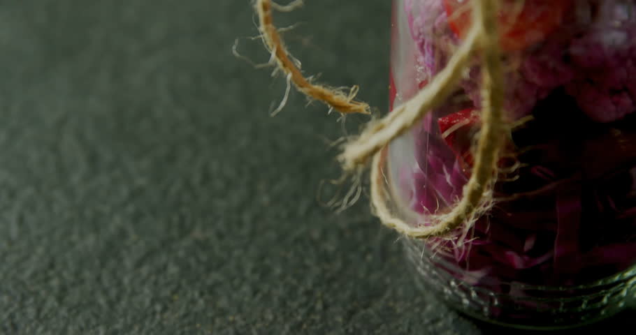 Starting extreme closeup on jute twine wrapped glass jar, HUD overlay appearing updating data gauge. Technology, data, futuristic, digital, innovation, analytics, modern