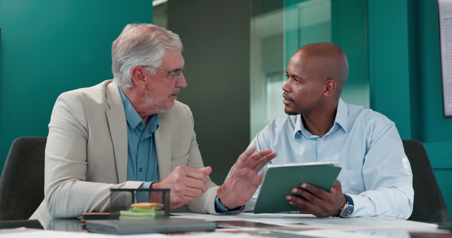 Business, men and meeting with tablet in office for discussion, planning and finance proposal. People, talking and digital with teamwork, financial pitch and budget feedback of investment negotiation