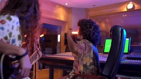 Musicians engaged in a creative session, collaborating on a song in a colorful recording studio environment - Powered by Shutterstock - Get 15% off with code: PIKWIZARD15