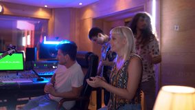 Musicians in a vibrant recording studio collaborate and celebrate progress, highlighting teamwork and creativity in music production - Powered by Shutterstock - Get 15% off with code: PIKWIZARD15