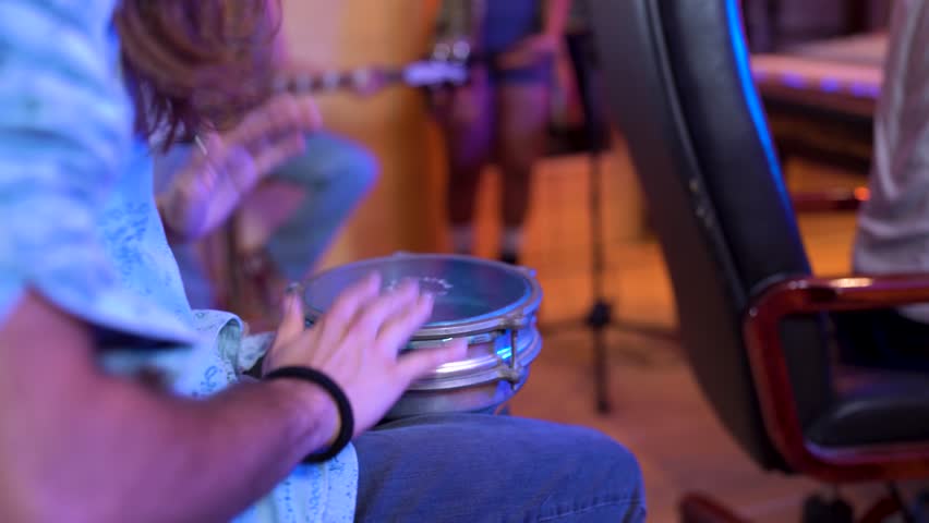 Professional musician performing darbuka drum during recording session, showcasing rhythmic skill and musical creativity in studio environment with focused concentration