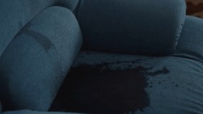 Red wine spilling from overturned bottle onto blue couch, creating large, dark stain and smaller droplets, suggesting accident or careless moment, close-up. Shooting in slow motion. - Powered by Shutterstock - Get 15% off with code: PIKWIZARD15